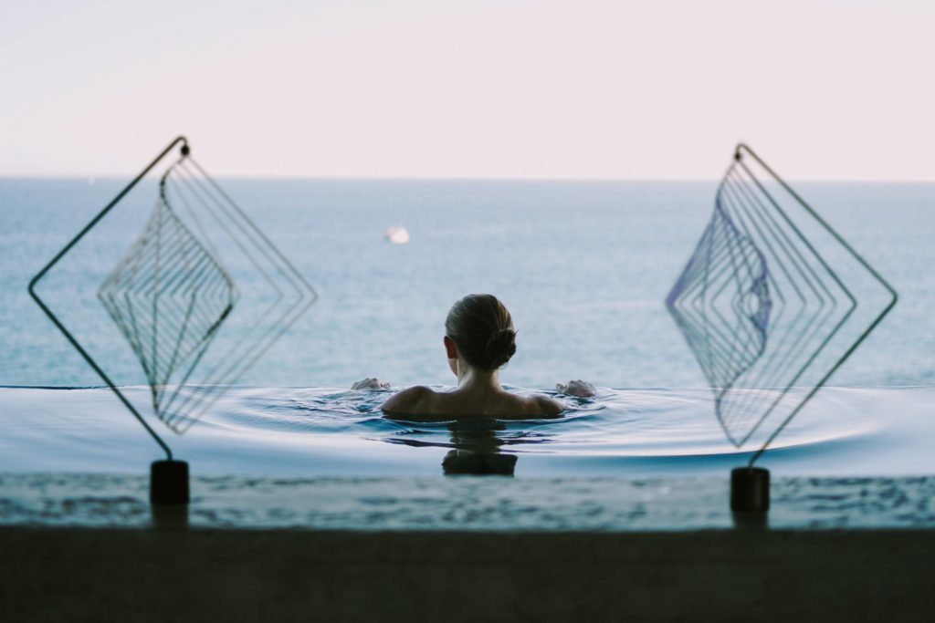 Relaxing in an infinite pool with two Square Wave sculptures